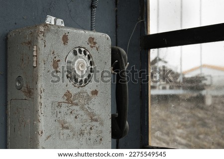 old phone in a phone booth.