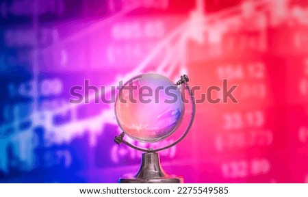 World economic and stock concept.Crystal globe with index stock market graph background. Royalty-Free Stock Photo #2275549585
