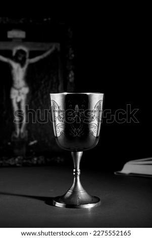 golden chalice with picture of crucified christ ,black and white