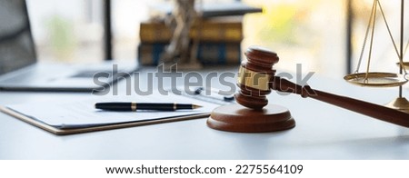image of judge's hammer, scales lady of justice, law book, laptop computer and contract documents with pen concept of law and justice. Royalty-Free Stock Photo #2275564109