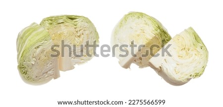 Cabbage fly in mid air, green fresh vegetable cabbage cut chop half quarter head. Organic fresh vegetable with eaten leaf of cabbage falling, close up texture. White background isolated freeze motion