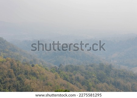 Over view of mountain and forest with bad visibility, Smog or dust PM 2.5 (Particulate matter with diameter of less than 2.5 micron) Bad weather and dangerous air pollution in Northern of Thailand.