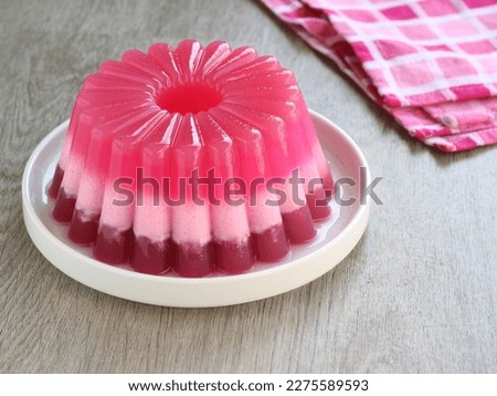 puding lapis pink or pink layered pudding. this desert made of coconut milk and pink powder pudding. popular for break fasting in month ramadan. selected focus