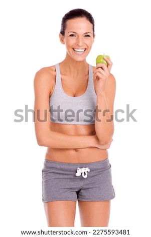 Great health begins with good eating. Portrait of an attractive young woman in sportswear holding an apple. Royalty-Free Stock Photo #2275593481
