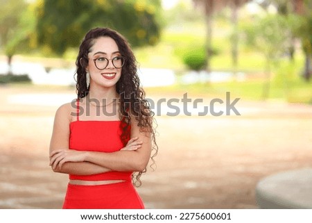 woman girl student with glasses curly hair arms crossed, businesswoman smiling