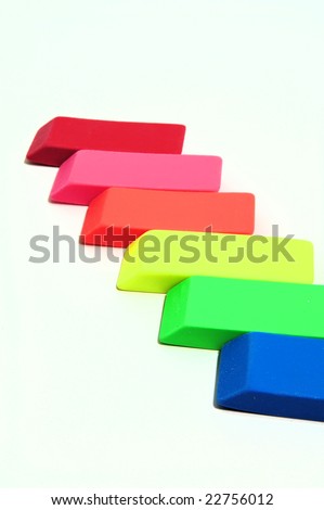 Erasers in various color shades on a light colored background