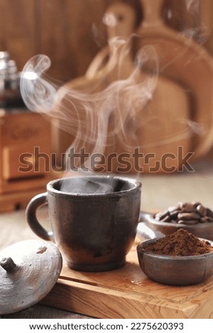 Coffee is a drink prepared from roasted coffee beans. Darkly colored, bitter, and slightly acidic, coffee has a stimulating effect on humans, primarily due to its caffeine content. It has the highest  Royalty-Free Stock Photo #2275620393