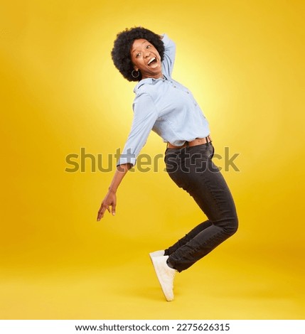 Wow, excited and black woman in dance pose on yellow background with energy, happiness and smile in studio. Winner mockup, celebration and isolated happy girl dancing for freedom, winning and success