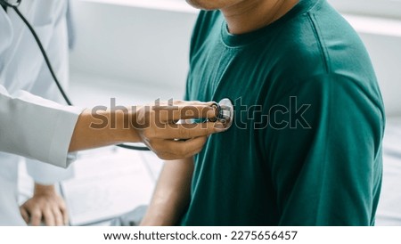Male patient consulting a medical specialist at hospital. Listening to the heartbeat with a stethoscope