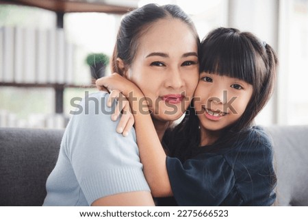 Closeup attractive lovely smile mother and little daughter girl eye close embrace and enjoy family love moment