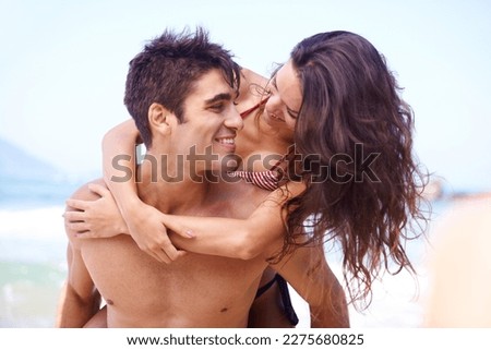 Riding on romance. a young couple enjoying a beach getaway. Royalty-Free Stock Photo #2275680825
