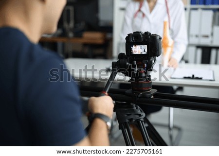 Videographer is filming doctor for online consultation and training Royalty-Free Stock Photo #2275705161