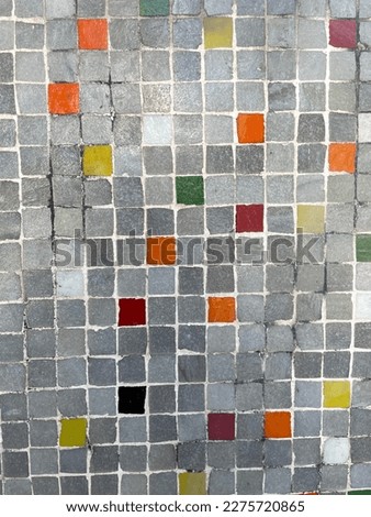 tile texture with small squares of gray yellow and red colors