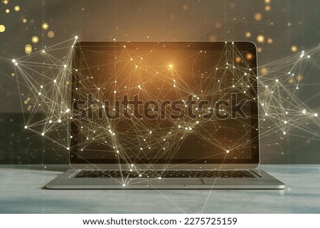 Close up of laptop with glowing polygonal mesh interface on blurry desktop background. Technology and network concept. Double exposure