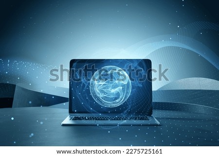 Close up of laptop computer on desktop with polygonal globe hologram on blurry background. World map with global social network. Future concept. Blue futuristic background with planet. Double exposure