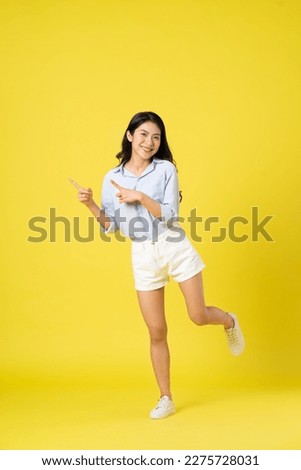 full body image of beautiful asian girl, isolated on yellow background