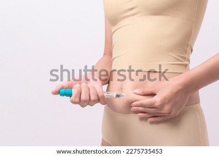 Close up woman using IVF treatment injection on belly to prepare reproductive fertility , Ovulation stimulation .	 Royalty-Free Stock Photo #2275735453