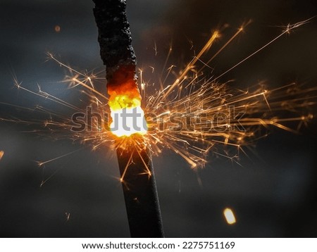 sparks flying after lighting a sparkler Royalty-Free Stock Photo #2275751169