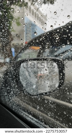 Raindrops on the window of the car.