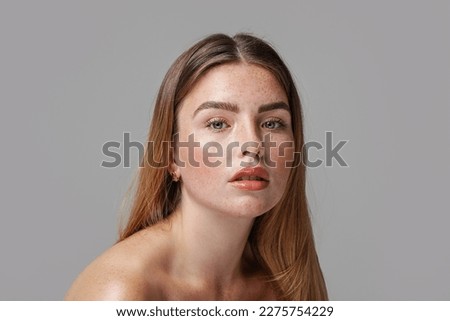 Studio beauty portrait of very natural woman with freckles on her face. Girl looking at the camera. A lot of copy space. Skin care concept. Ideal, delicate makeup.  Royalty-Free Stock Photo #2275754229