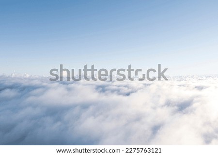 Aerial view White clouds in blue sky. Top. View from drone. Aerial bird's eye. Aerial top view cloudscape. Texture of clouds. View from above. Sunrise or sunset over clouds Royalty-Free Stock Photo #2275763121