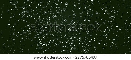 Atmospheric minimal monochrome backdrop with rain droplets on glass. Wet window with rainy drops and dirt spots closeup. Blurry minimalist background of dirty window glass with raindrops close up. Royalty-Free Stock Photo #2275785497