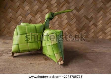 Close up view of Ketupat, an Indonesian traditional cuisine very popular during Hari Raya Idul Fitri. Ketupat is a natural rice casing made from young coconut leaves for cooking rice. Royalty-Free Stock Photo #2275785715