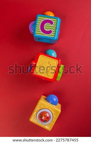 baby toys on red background. vertical photo