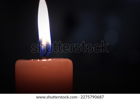 Pic of candle burning in dark