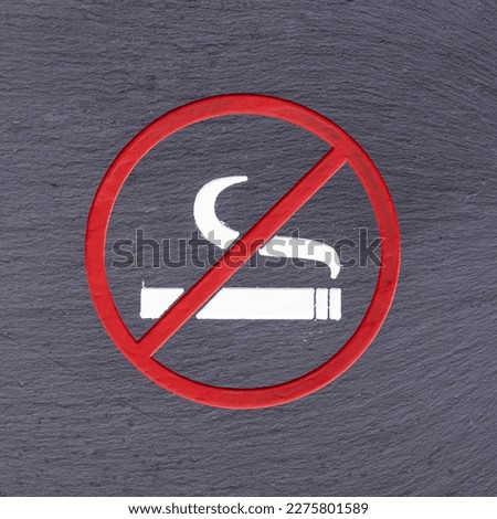 Red 'no smoking' sign on grey background