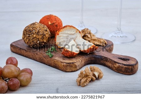 Belper Knolle cheese with spices on a wooden board with nuts and grapes. Cheese plate for white wine Royalty-Free Stock Photo #2275821967
