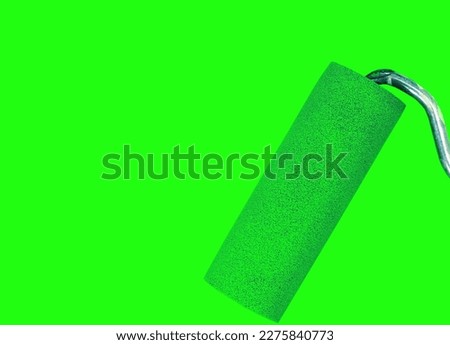 Paint roller leaving stroke of green color over a white background. usable for text and messages.