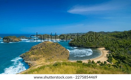 Kasap Beach is located in Pacitan, East Java, Indonesia whose scenery is similar to Raja Ampat Papua. Top view high angle of beautiful beach. Sunny weather during the day. Royalty-Free Stock Photo #2275854469
