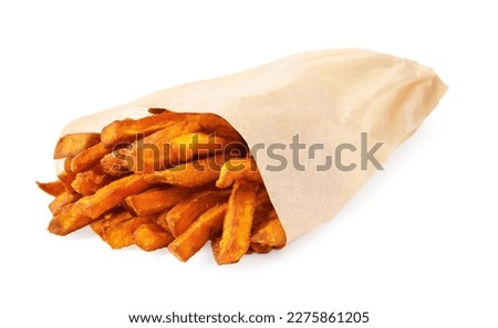 Paper bag with tasty sweet potato fries isolated on white