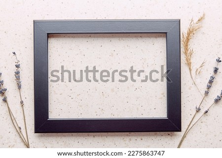 Aesthetic empty interior black wall frame mockup, minimalist fine art template with lavender and cane flat lay.
