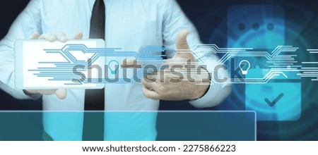 Businessman holding Mobile Phone Pointing to Screen Showing The main Message. Man Presenting Cell Phone Inside Room Presenting Modern Automation. Futuristic.