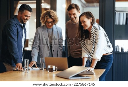 Successful business team connecting with their clients on a video call. Happy business people having an online meeting in an office. Networking and collaboration in a creative workplace.