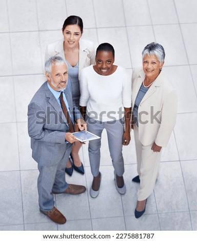 Theyre a force to be reckoned with. HIgh angle portrait of a diverse and confident group of businesspeople standing with a digital tablet. Royalty-Free Stock Photo #2275881787