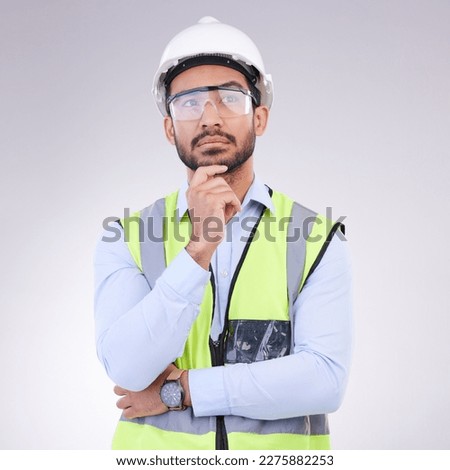 Construction worker thinking, serious man with ideas and architect or engineer in building industry on studio background. Male contractor, mockup and professional builder with helmet and goggles Royalty-Free Stock Photo #2275882253