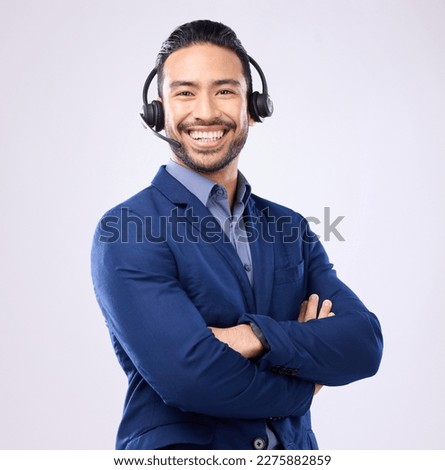Portrait, customer service and arms crossed with a man consultant standing in studio on a gray background. Contact us, support and headset with a male telecom worker ready to help for assistance Royalty-Free Stock Photo #2275882859