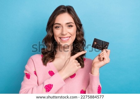 Photo portrait of pretty girl hold point credit card dressed stylish pink strawberry print clothes isolated on blue color background