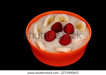 Cream of Wheat,bananas amd Ransberries isolated over a black background