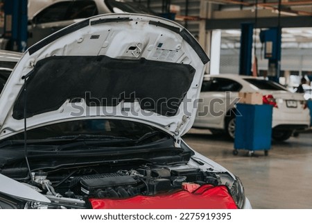 Car crash open hood car mechanic to check condition of damage. See the radiator cooling panel Engine and electronic system for mechanic to check damage thoroughly to repair engine to complete for use. Royalty-Free Stock Photo #2275919395