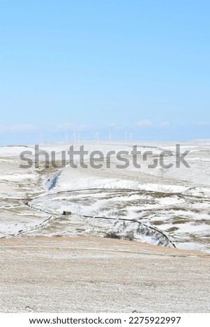 Aerial view of snow covered mountains with a clear blue sky background. Taken in Bury Lancashire England. 