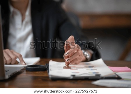 Businesswoman stamping on documents approve business successful.
