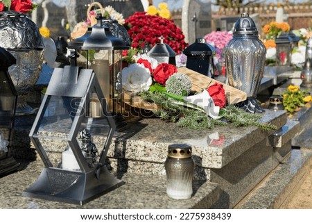 Glass candles on a tombstone, symbolism of remembrance of the dead.
