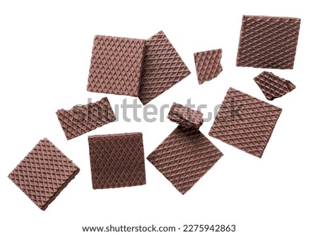 Chocolate wafers and broken pieces are flying on a white background. Isolated Royalty-Free Stock Photo #2275942863