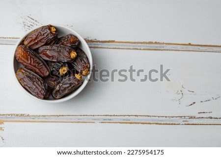 Dried date fruits, Ramadan Kareem, white wooden background, copy space, top view.