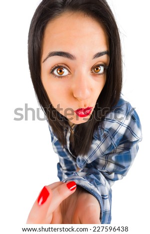 Beautiful girl making duckface while taking a selfie.