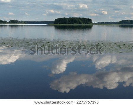 Clouds are reflected in the water of the lake.